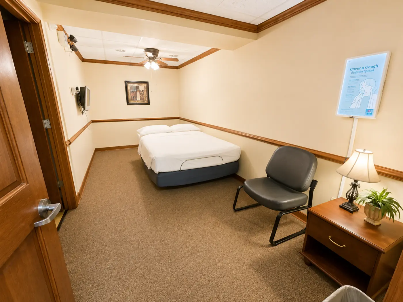 Private sleep room with bed and chair
