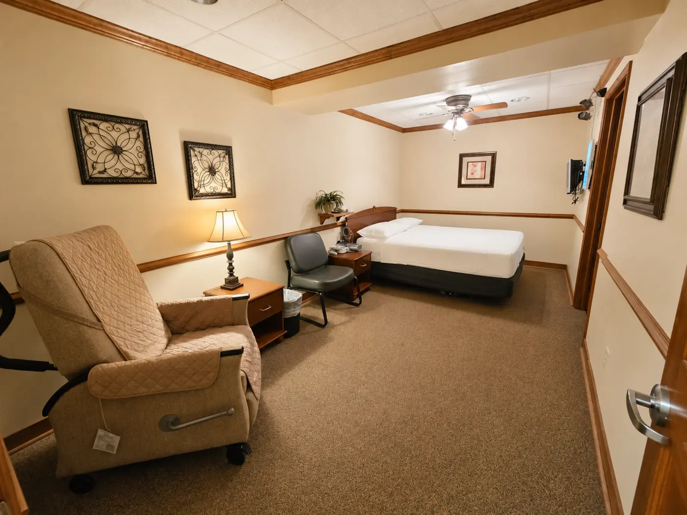 Spacious private sleep room with bed and recliner