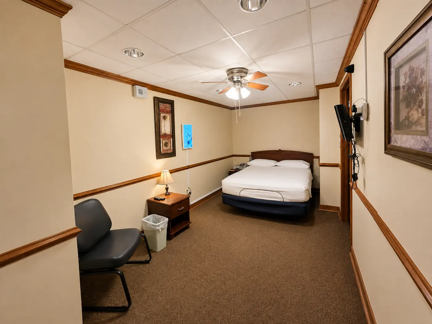 Private sleep room with bed, chair, and television
